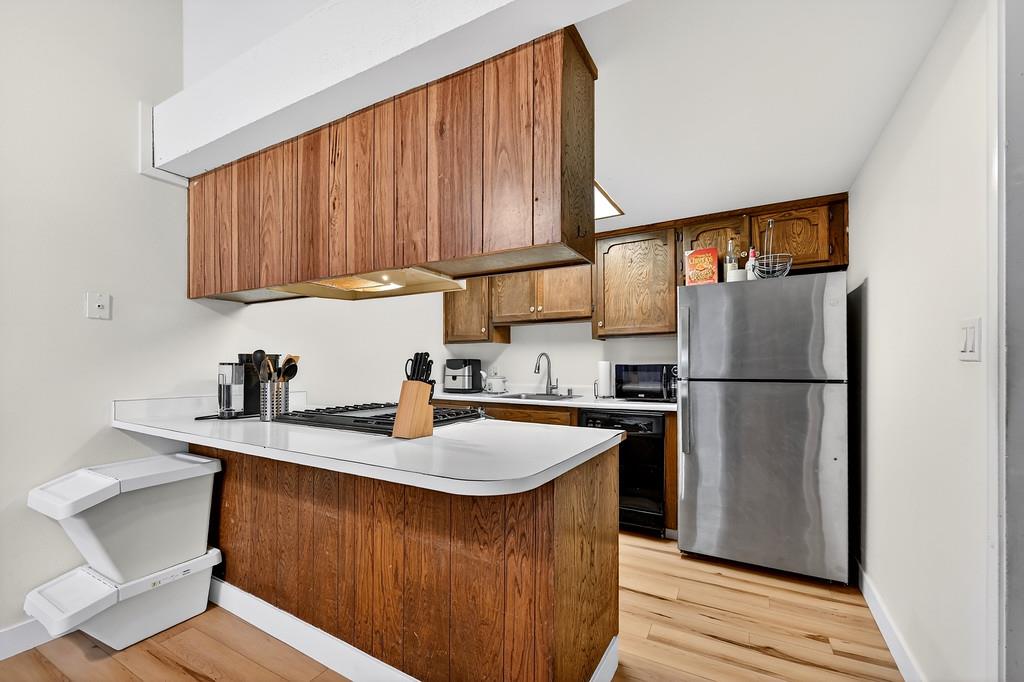 1052 Clinton Road Sacramento, CA 95825 - Photo 13 of 52 a kitchen with a refrigerator sink and cabinets