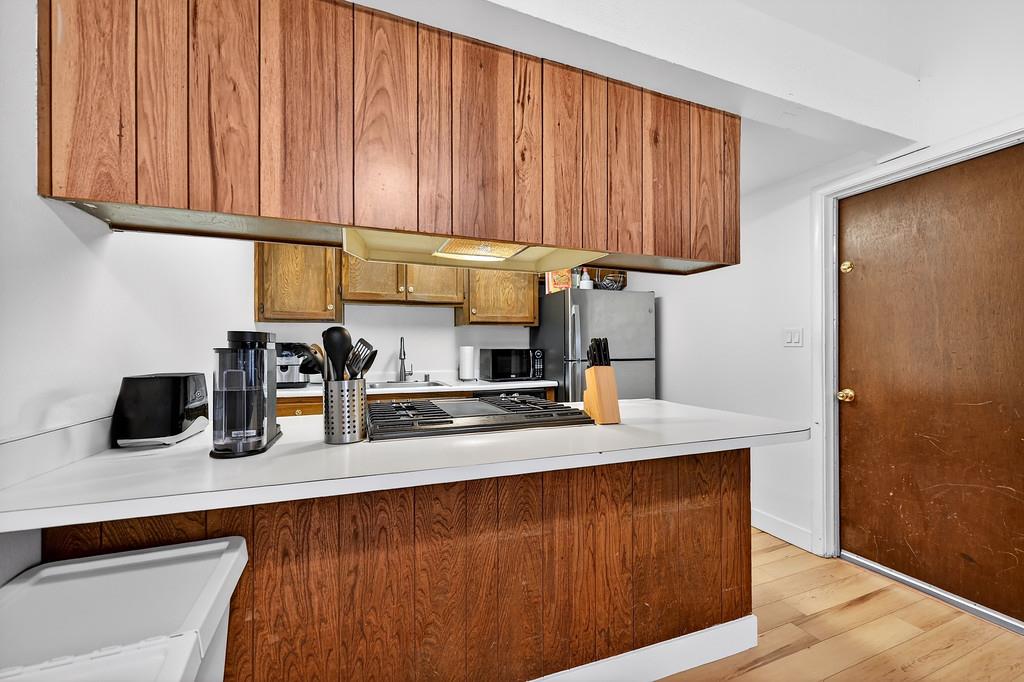 1052 Clinton Road Sacramento, CA 95825 - Photo 14 of 52 a kitchen with stainless steel appliances granite countertop wooden cabinets a refrigerator and sink