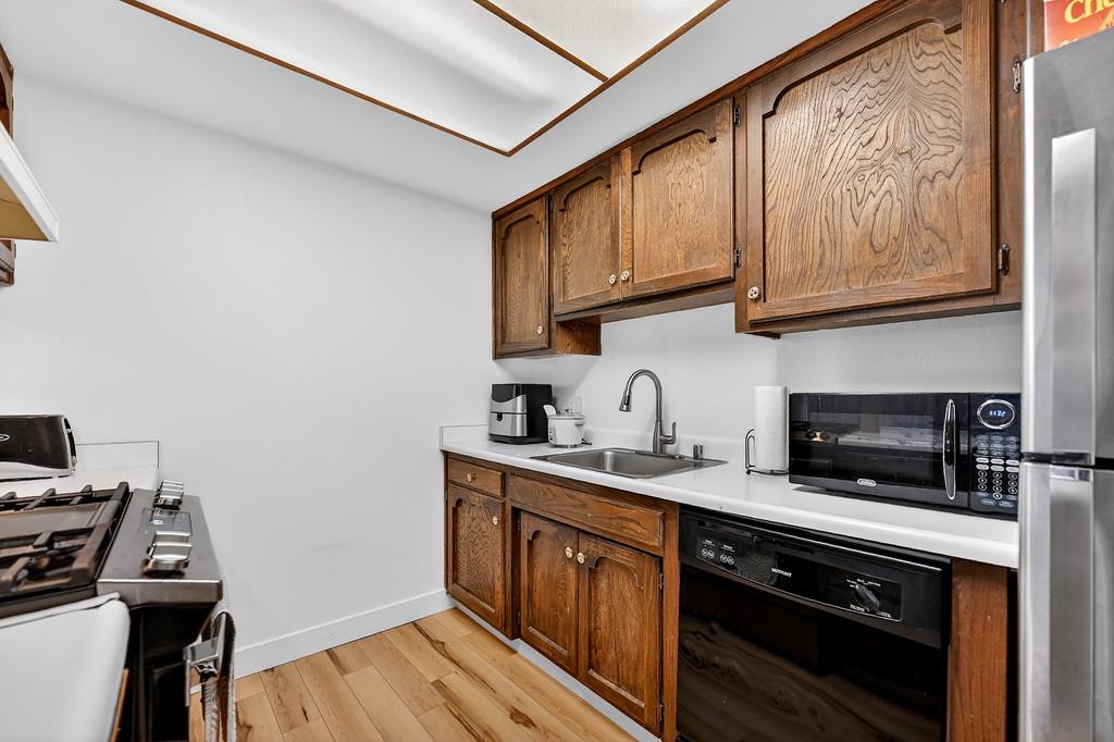 1052 Clinton Road Sacramento, CA 95825 - Photo 15 of 52 a kitchen with stainless steel appliances granite countertop a stove a sink and a microwave