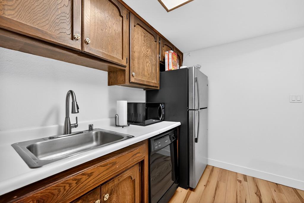 1052 Clinton Road Sacramento, CA 95825 - Photo 17 of 52 a kitchen with stainless steel appliances granite countertop a sink and a refrigerator