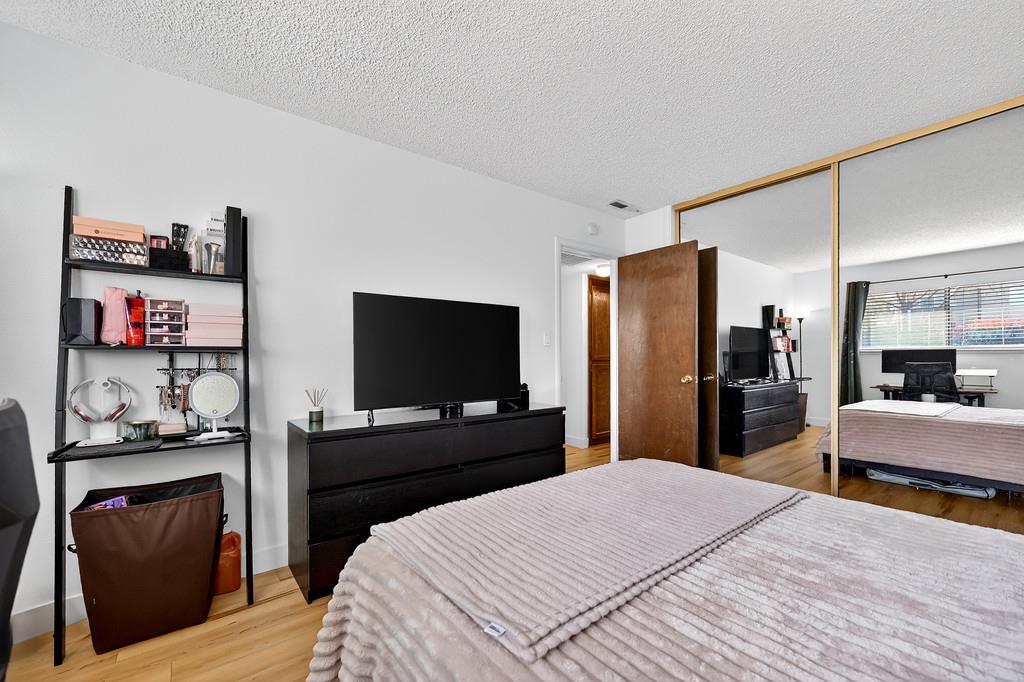1052 Clinton Road Sacramento, CA 95825 - Photo 19 of 52 a bedroom with a bed and a flat screen tv