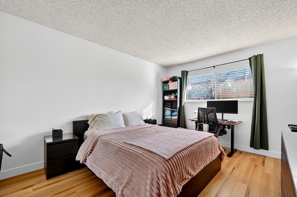 1052 Clinton Road Sacramento, CA 95825 - Photo 20 of 52 a bed sitting in a bedroom next to a window with a flat tv screen and a table