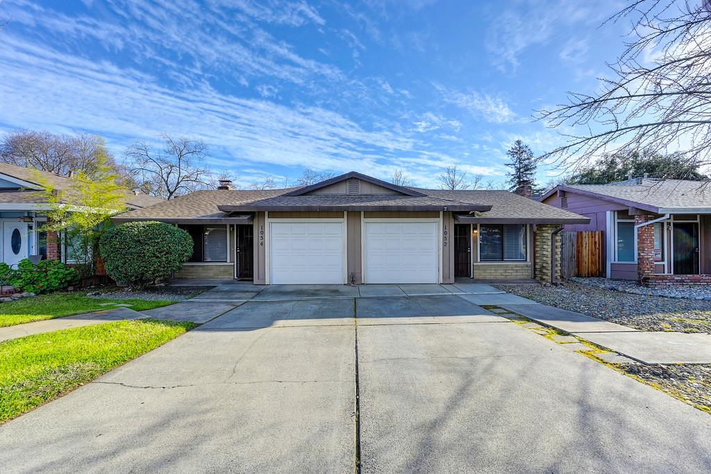 1052 Clinton Road Sacramento, CA 95825 - Photo 2 of 52 a front view of a house with a yard and potted plants