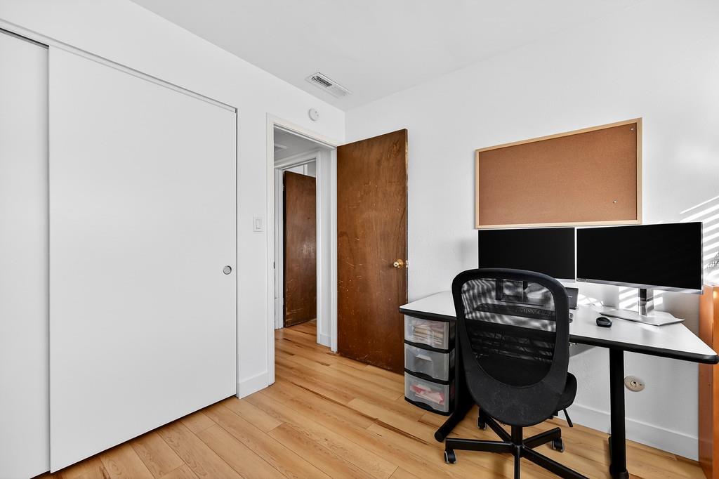1052 Clinton Road Sacramento, CA 95825 - Photo 22 of 52 a workspace with furniture and wooden floor
