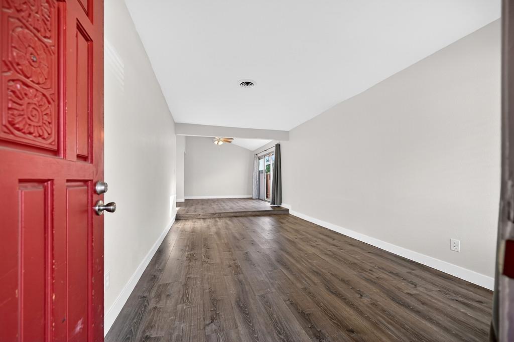 1052 Clinton Road Sacramento, CA 95825 - Photo 29 of 52 a view of an empty room with wooden floor and a window