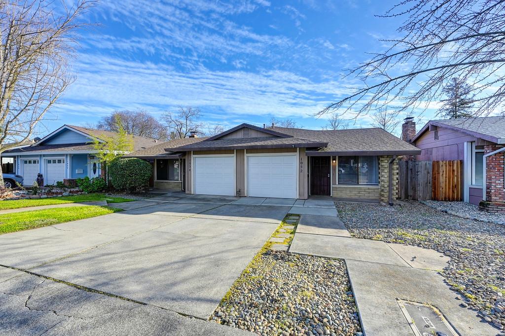 1052 Clinton Road Sacramento, CA 95825 - Photo 3 of 52 a front view of a house with a yard and garage