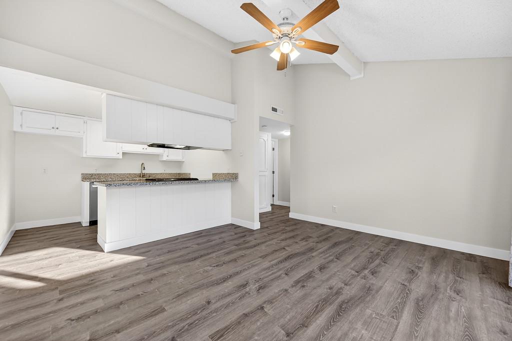 1052 Clinton Road Sacramento, CA 95825 - Photo 35 of 52 a view of a kitchen with wooden floor and a ceiling fan