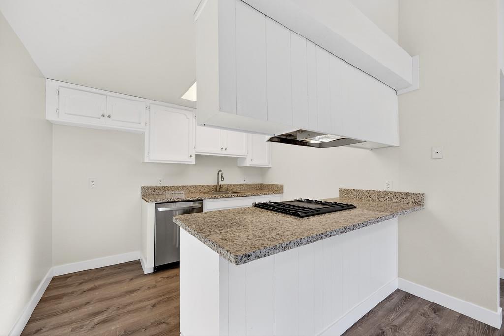 1052 Clinton Road Sacramento, CA 95825 - Photo 37 of 52 a kitchen with granite countertop cabinets a sink and a stove
