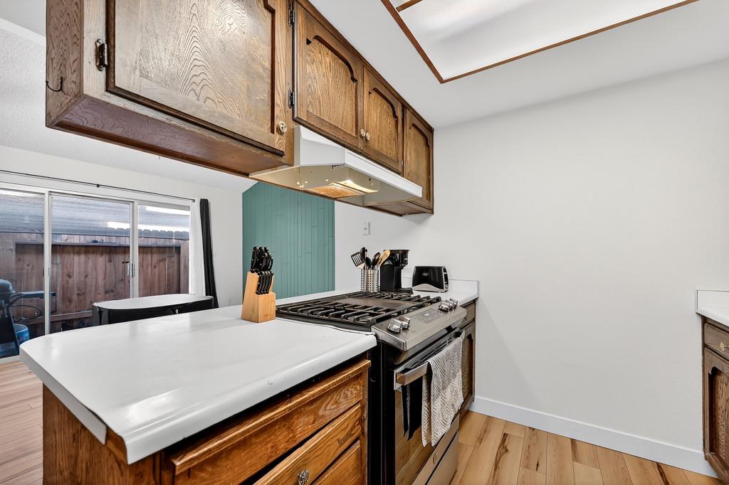 1052 Clinton Road Sacramento, CA 95825 - Photo 38 of 52 a kitchen with stainless steel appliances granite countertop a stove a sink and a microwave