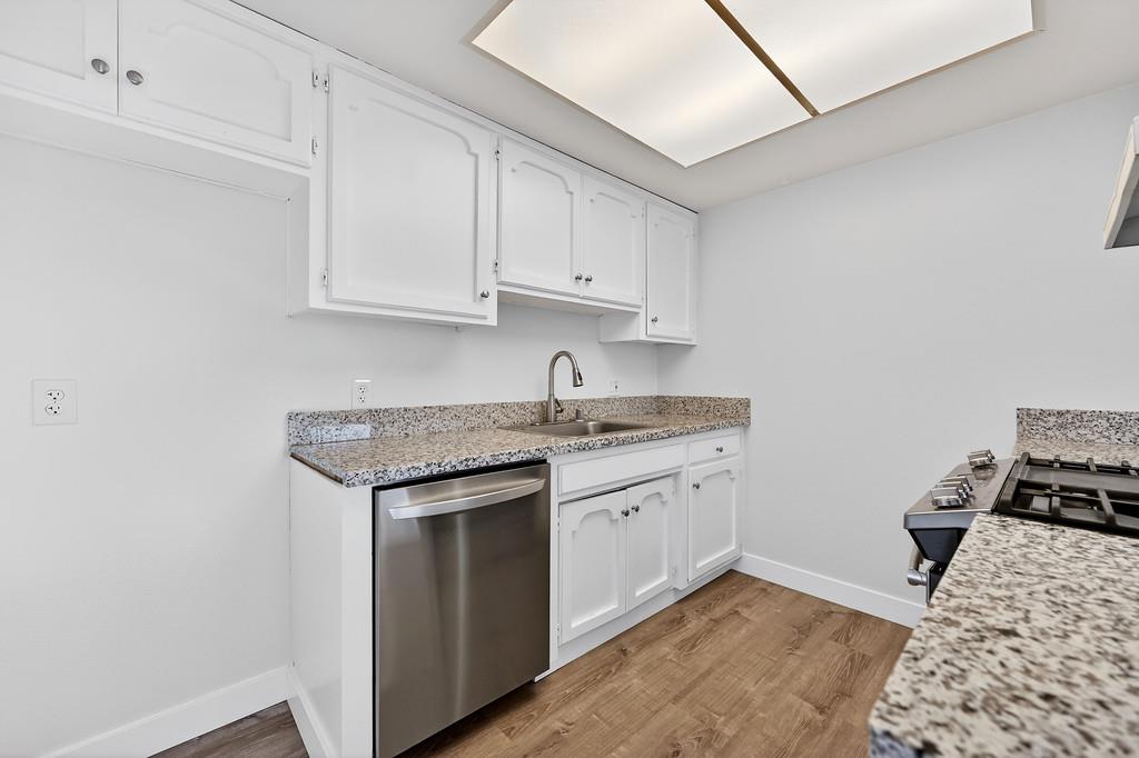 1052 Clinton Road Sacramento, CA 95825 - Photo 39 of 52 a kitchen with granite countertop a sink stove and cabinets