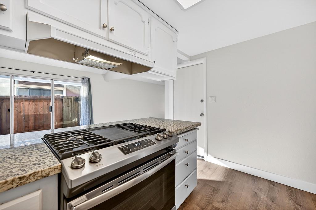 1052 Clinton Road Sacramento, CA 95825 - Photo 40 of 52 a stove top oven sitting inside of a kitchen