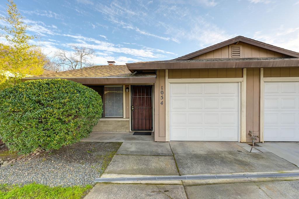 1052 Clinton Road Sacramento, CA 95825 - Photo 4 of 52 a front view of a house with a yard and garage