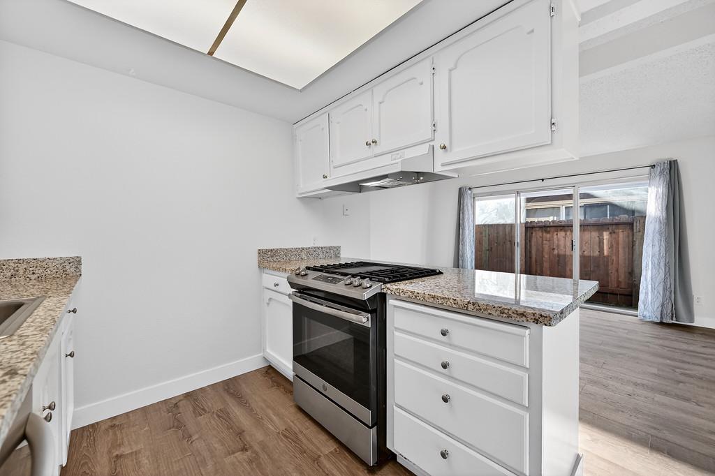 1052 Clinton Road Sacramento, CA 95825 - Photo 41 of 52 a kitchen with granite countertop white cabinets and stainless steel appliances
