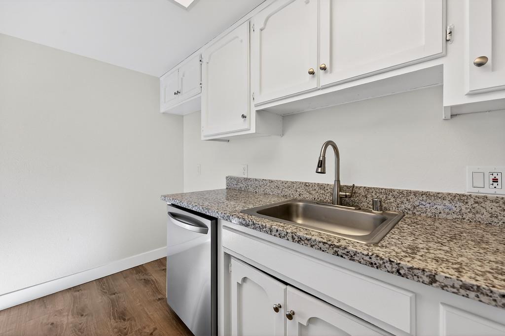 1052 Clinton Road Sacramento, CA 95825 - Photo 42 of 52 a kitchen with granite countertop a sink and cabinets