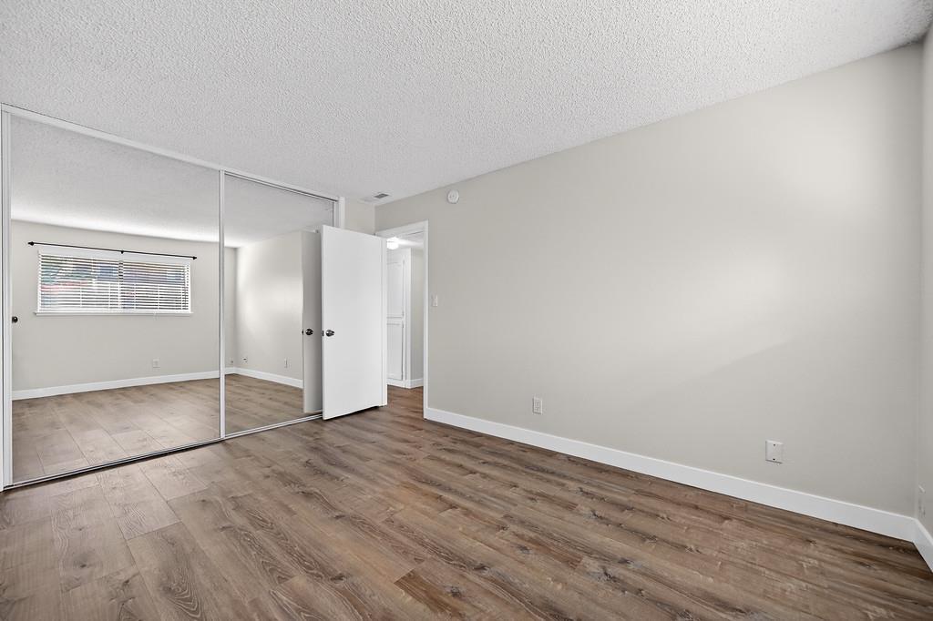 1052 Clinton Road Sacramento, CA 95825 - Photo 45 of 52 a view of an empty room with wooden floor and a window