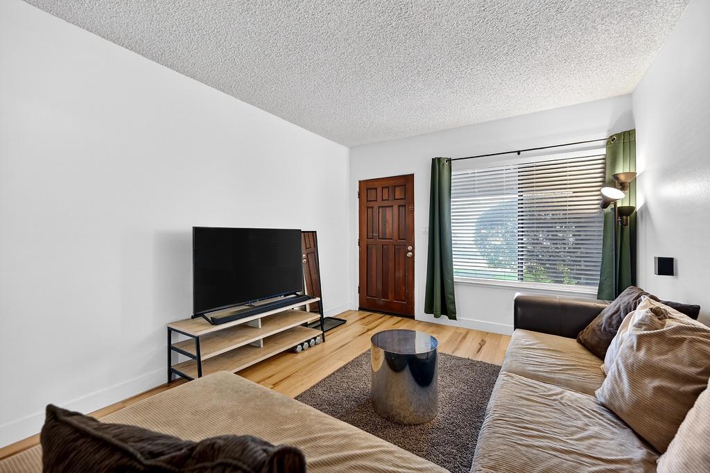 1052 Clinton Road Sacramento, CA 95825 - Photo 9 of 52 a living room with furniture and a flat screen tv