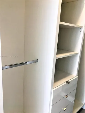a view of an empty walk in closet