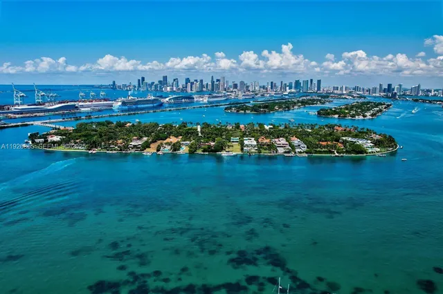 a view of a house with a big yard and large trees