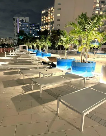 a view of a swimming pool with an outdoor seating