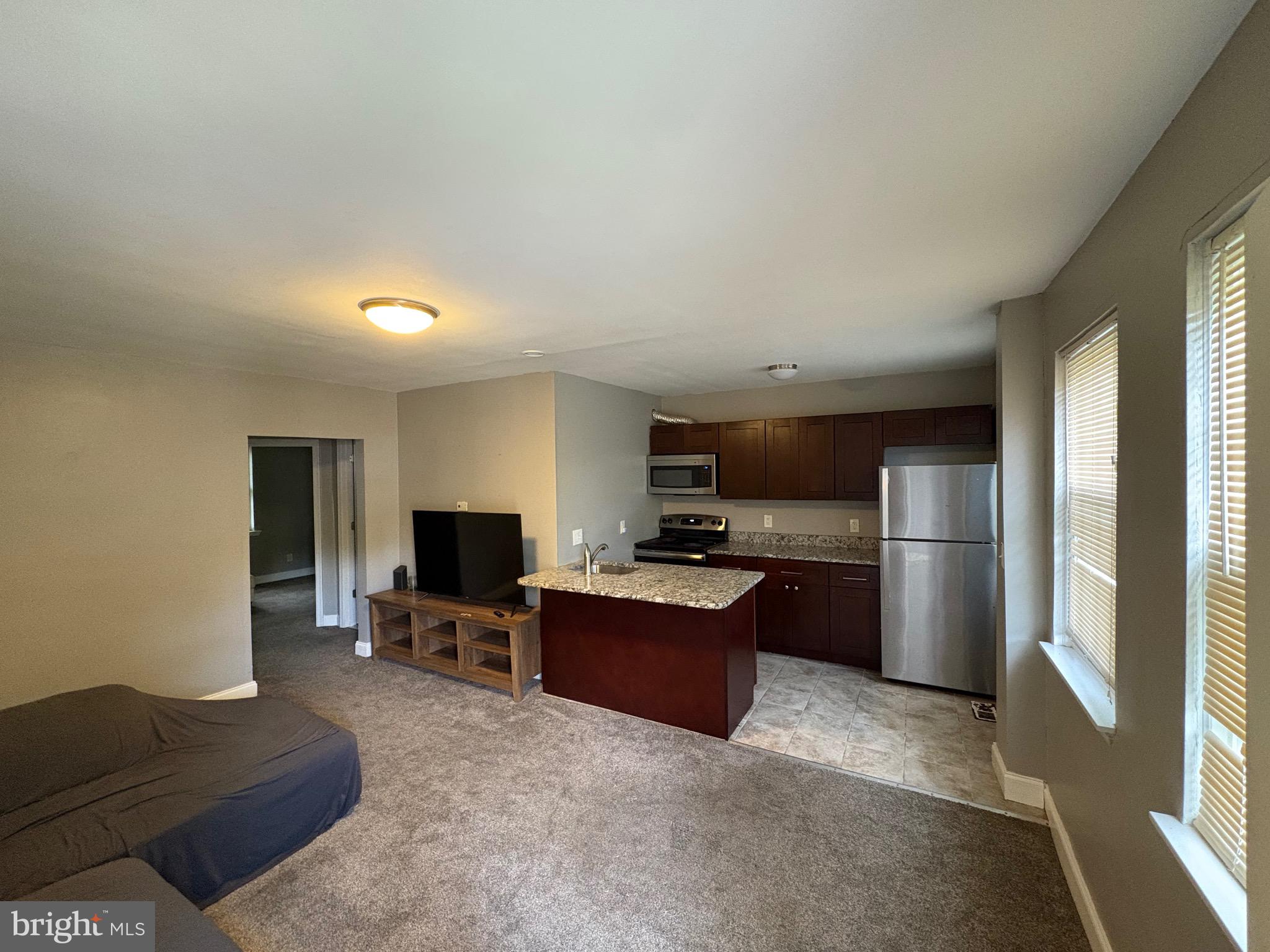 a living room with furniture and a flat screen tv
