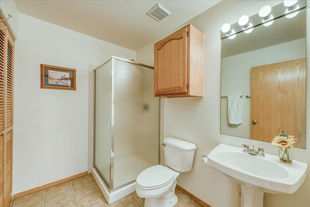 91399 Ryan Gulch Road, Unit B6 Silverthorne, CO 80498 - Photo 16 of 36 a bathroom with a sink toilet and shower