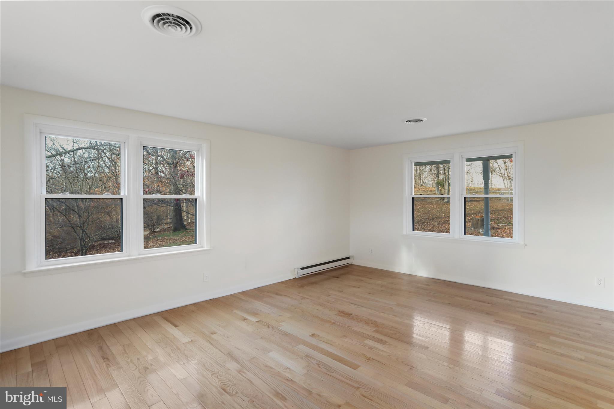 13 Oriole Circle Berkeley Springs, WV 25411 - Photo 13 of 36 a view of an empty room with a window and wooden floor