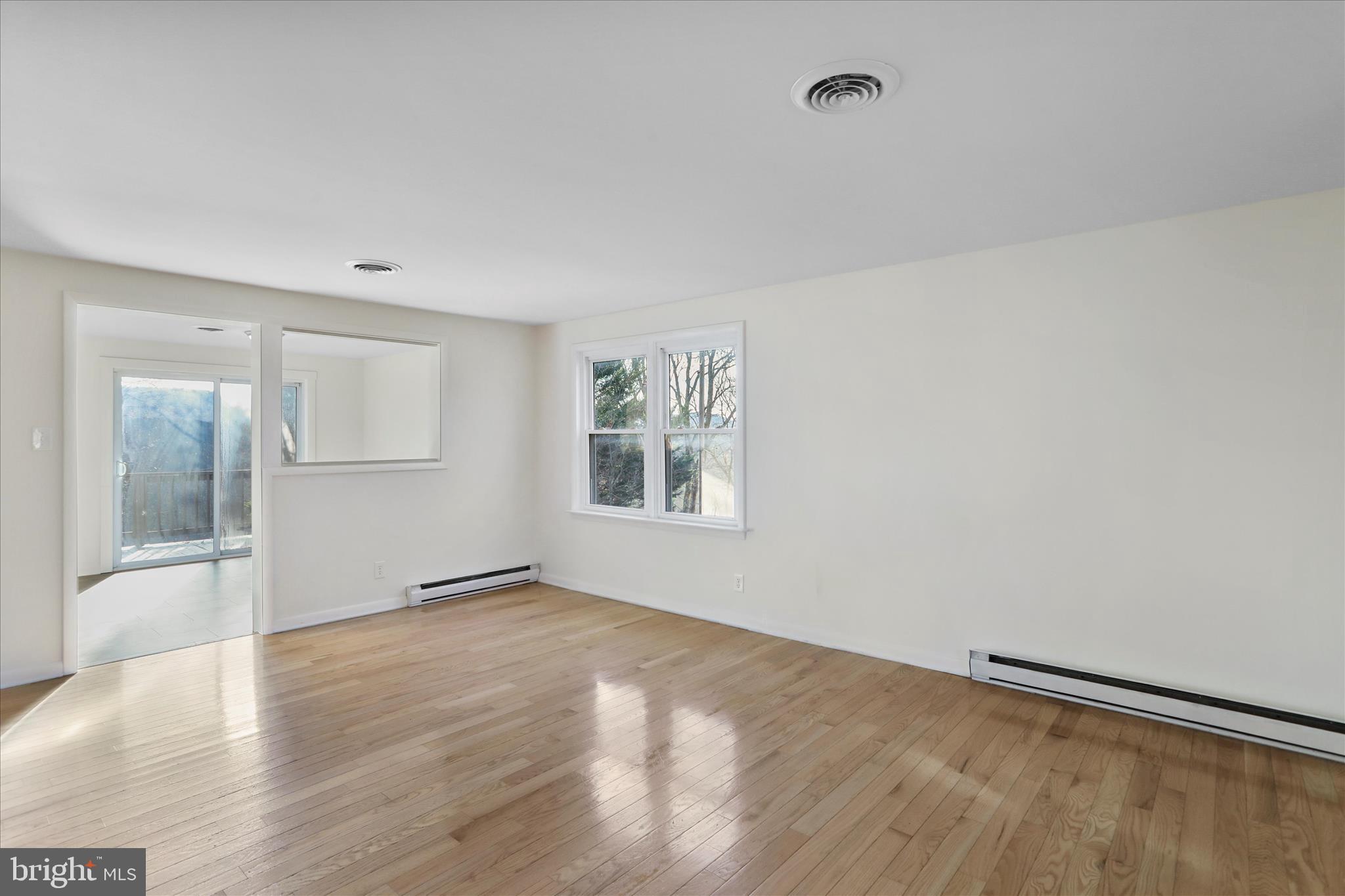 13 Oriole Circle Berkeley Springs, WV 25411 - Photo 14 of 36 wooden floor in an empty room with a window