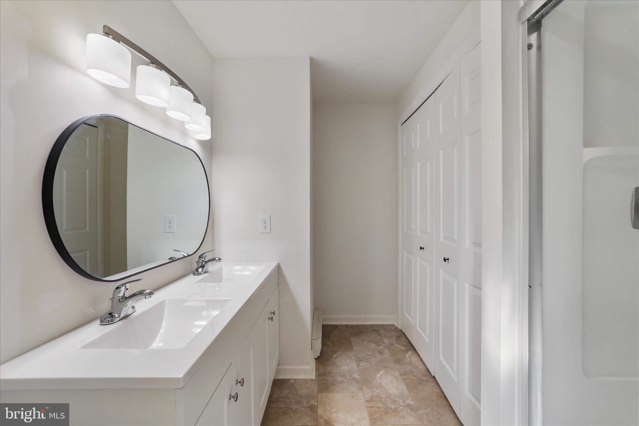 13 Oriole Circle Berkeley Springs, WV 25411 - Photo 20 of 36 a bathroom with a double vanity sink and a mirror