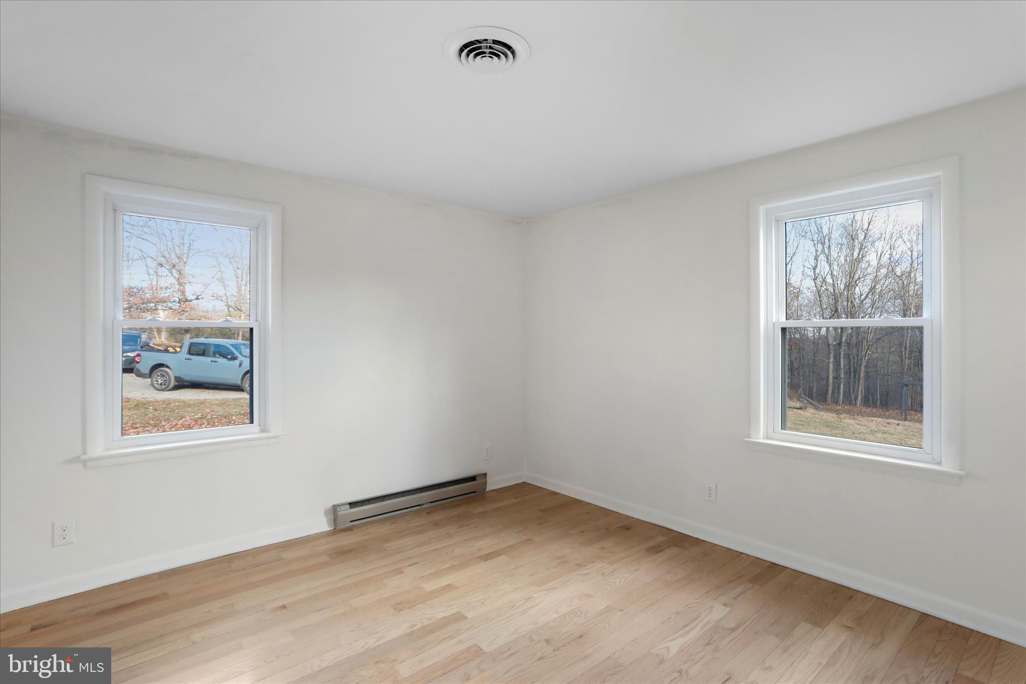 13 Oriole Circle Berkeley Springs, WV 25411 - Photo 21 of 36 a view of empty room with window and wooden floor