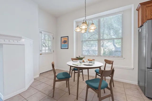 a view of a dining room with furniture wooden floor and chandelier