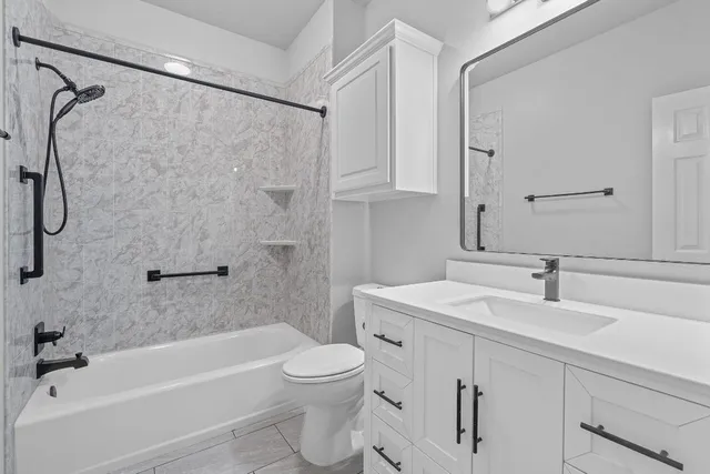 a bathroom with a sink a toilet and a bathtub