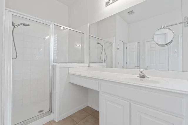 a bathroom with a sink vanity and a mirror