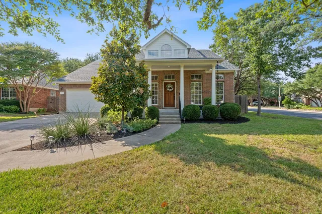 a front view of a house with a garden