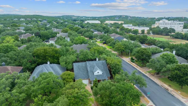 an aerial view of a house with a yard and lake view