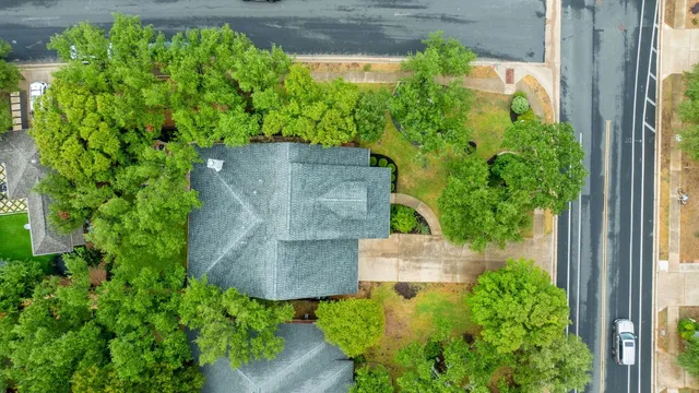 an aerial view of a house with a yard