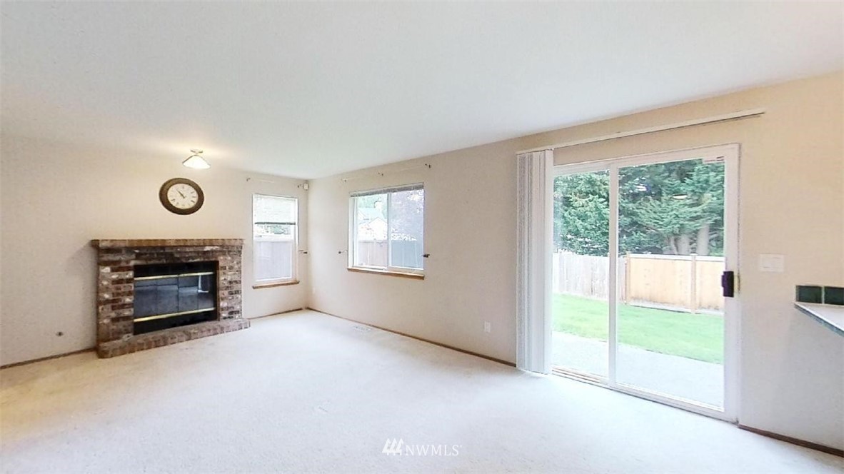 18607 104th Place Southeast Renton, WA 98055 - Photo 11 of 22 a view of an empty room with a fireplace and a window