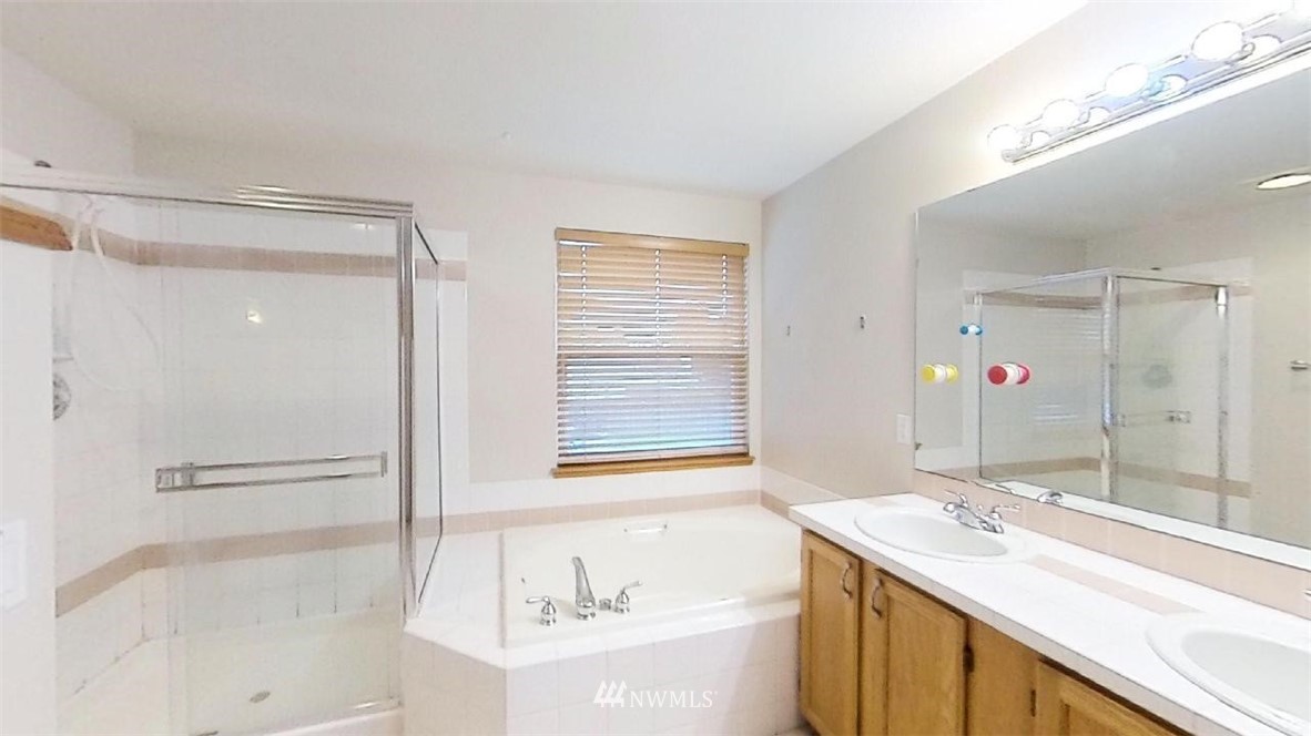 18607 104th Place Southeast Renton, WA 98055 - Photo 20 of 22 a bathroom with a tub sink and mirror