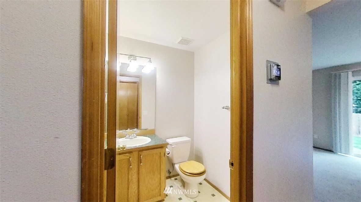 18607 104th Place Southeast Renton, WA 98055 - Photo 8 of 22 a bathroom with a granite countertop sink and a mirror