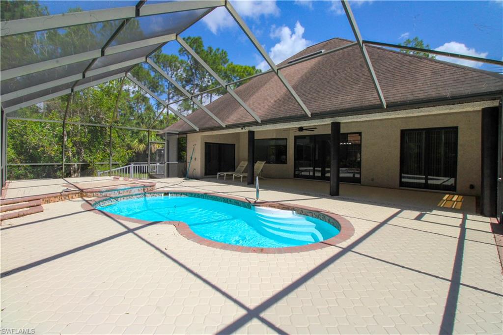 311 31st Street Northwest Naples, FL 34120 - Photo 14 of 50 a swimming pool with a table and chairs