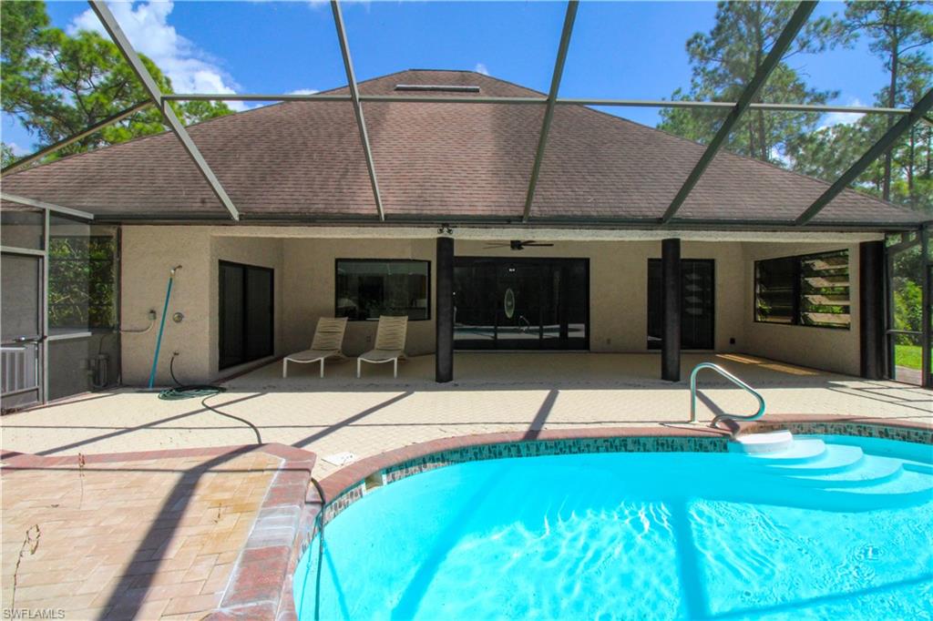 311 31st Street Northwest Naples, FL 34120 - Photo 15 of 50 a swimming pool with barbeque oven in front of it