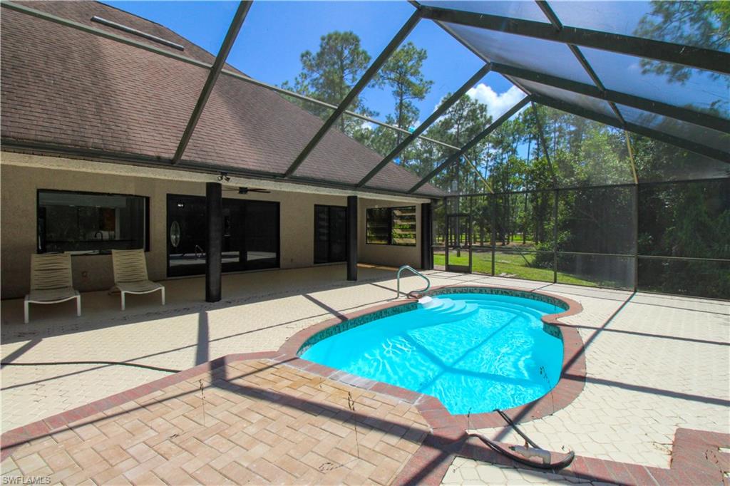 311 31st Street Northwest Naples, FL 34120 - Photo 16 of 50 a view of a backyard with a patio