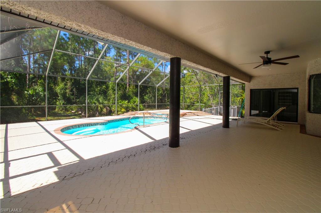 311 31st Street Northwest Naples, FL 34120 - Photo 17 of 50 a view of an empty room with floor to ceiling windows with yard
