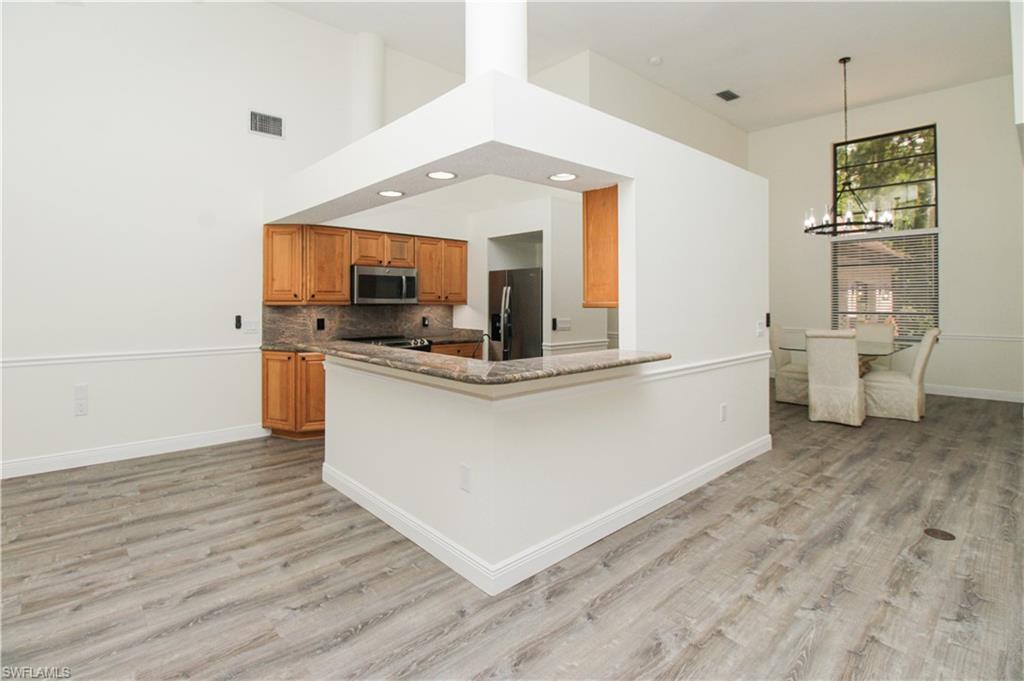 311 31st Street Northwest Naples, FL 34120 - Photo 21 of 50 a view of living room with granite countertop furniture and fireplace