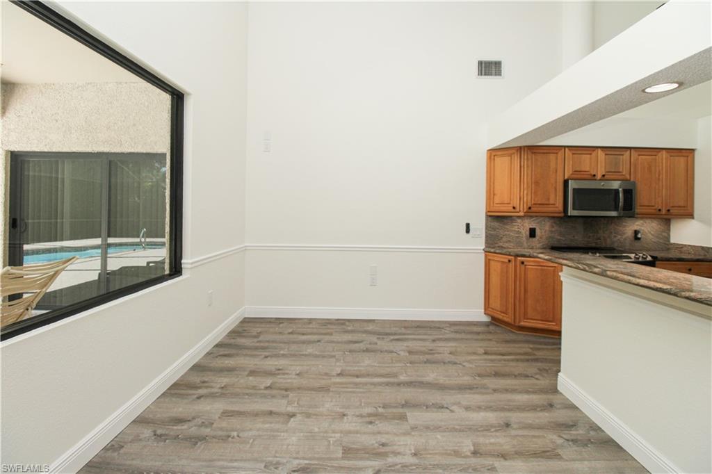 311 31st Street Northwest Naples, FL 34120 - Photo 22 of 50 a kitchen with granite countertop a sink and a stove top oven