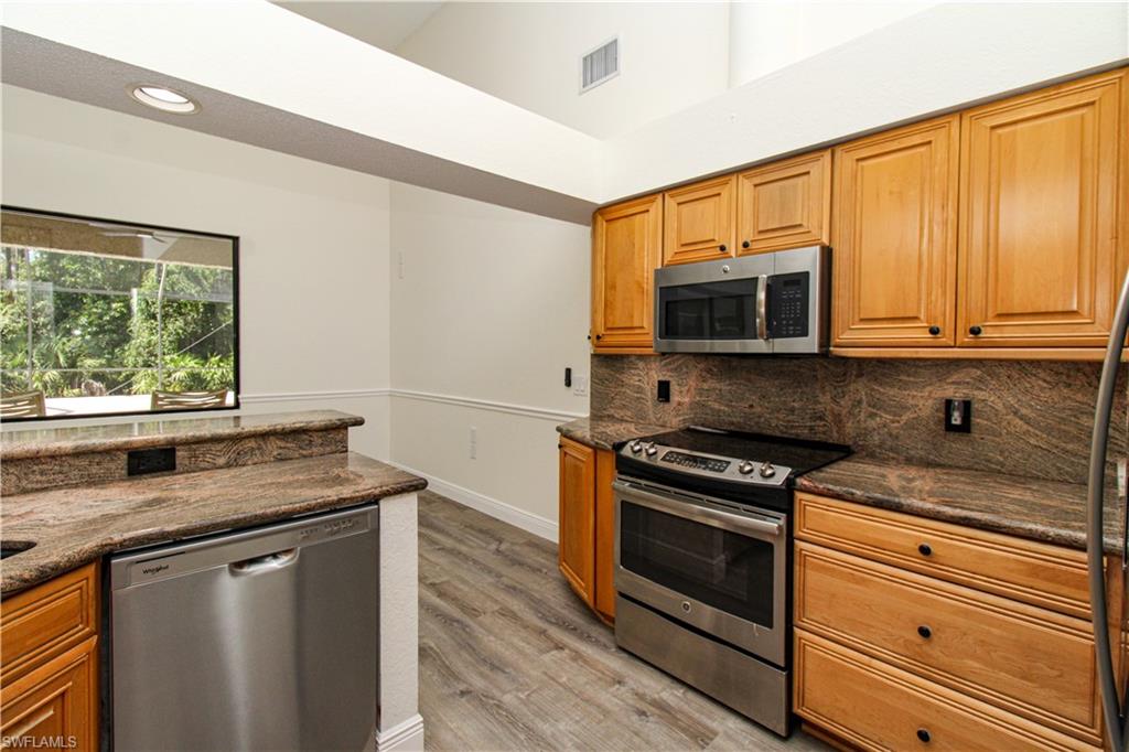 311 31st Street Northwest Naples, FL 34120 - Photo 27 of 50 a kitchen with stainless steel appliances a stove microwave and sink