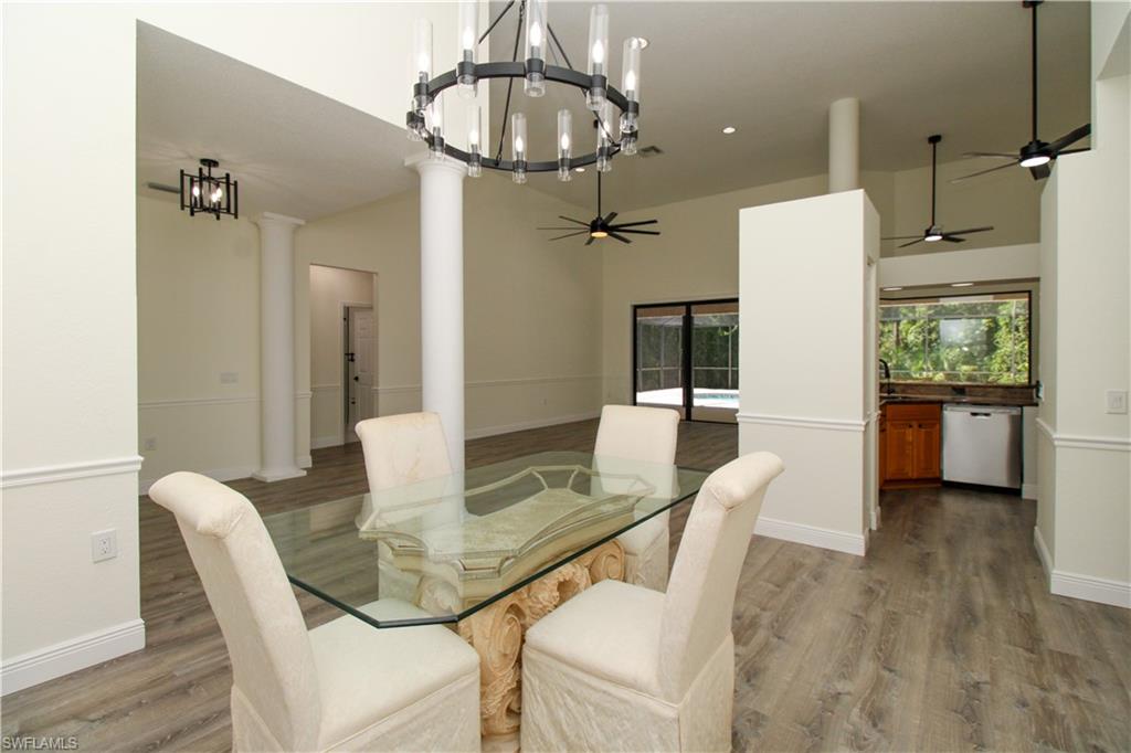 311 31st Street Northwest Naples, FL 34120 - Photo 30 of 50 a dining room with furniture and wooden floor