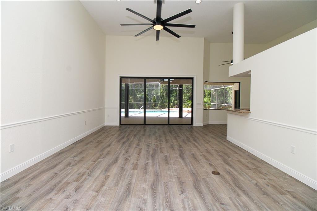 311 31st Street Northwest Naples, FL 34120 - Photo 32 of 50 wooden floor in an empty room with a window
