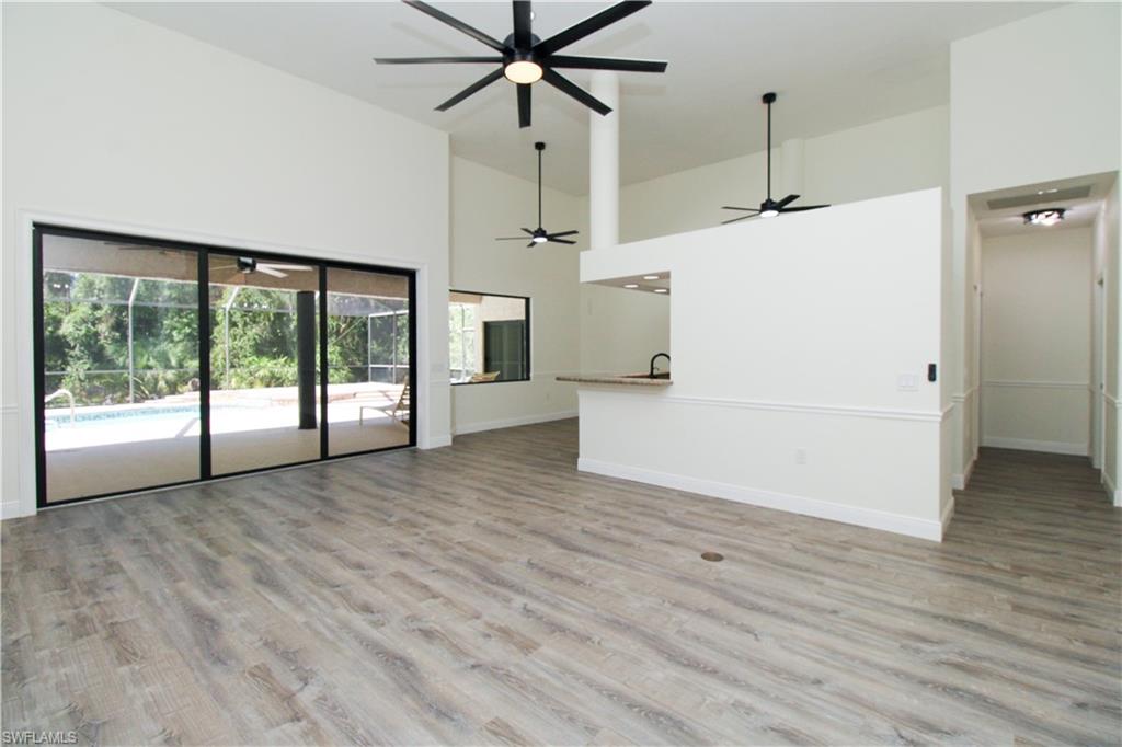311 31st Street Northwest Naples, FL 34120 - Photo 33 of 50 a view of empty room with wooden floor and ceiling fan