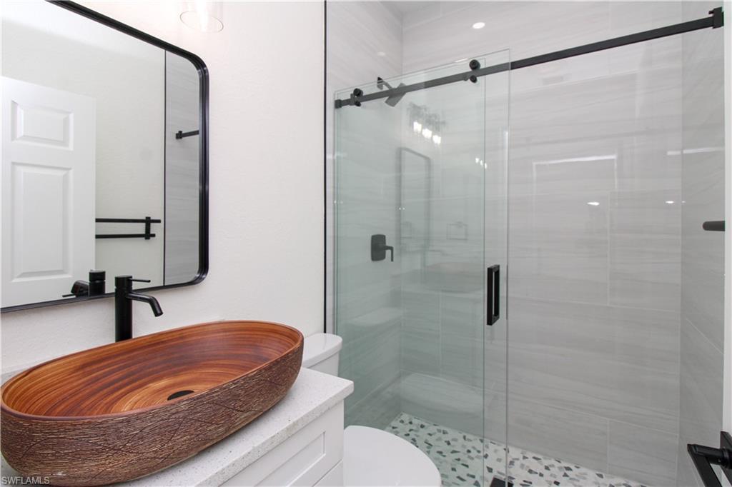 311 31st Street Northwest Naples, FL 34120 - Photo 35 of 50 a bathroom with a sink and a shower