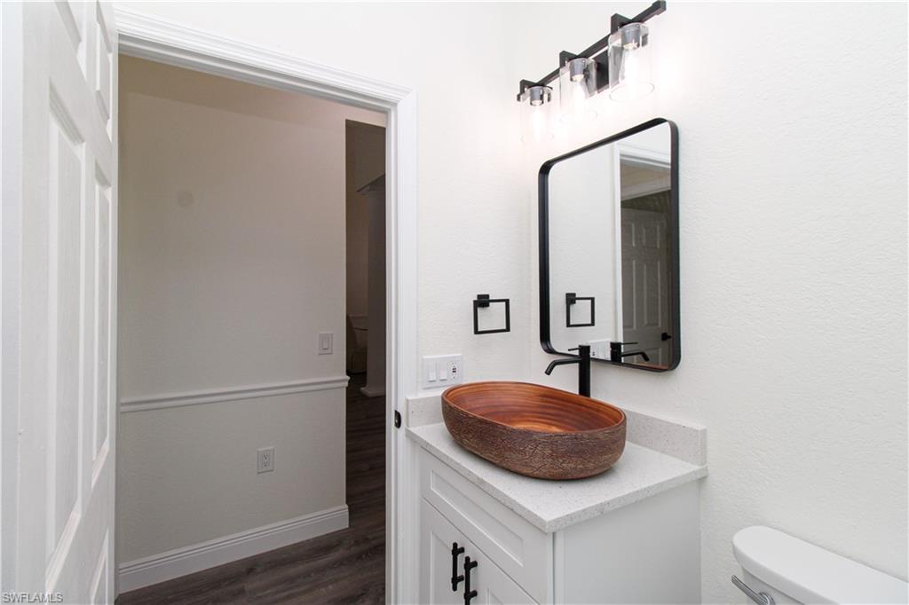 311 31st Street Northwest Naples, FL 34120 - Photo 36 of 50 a bathroom with a sink and a mirror